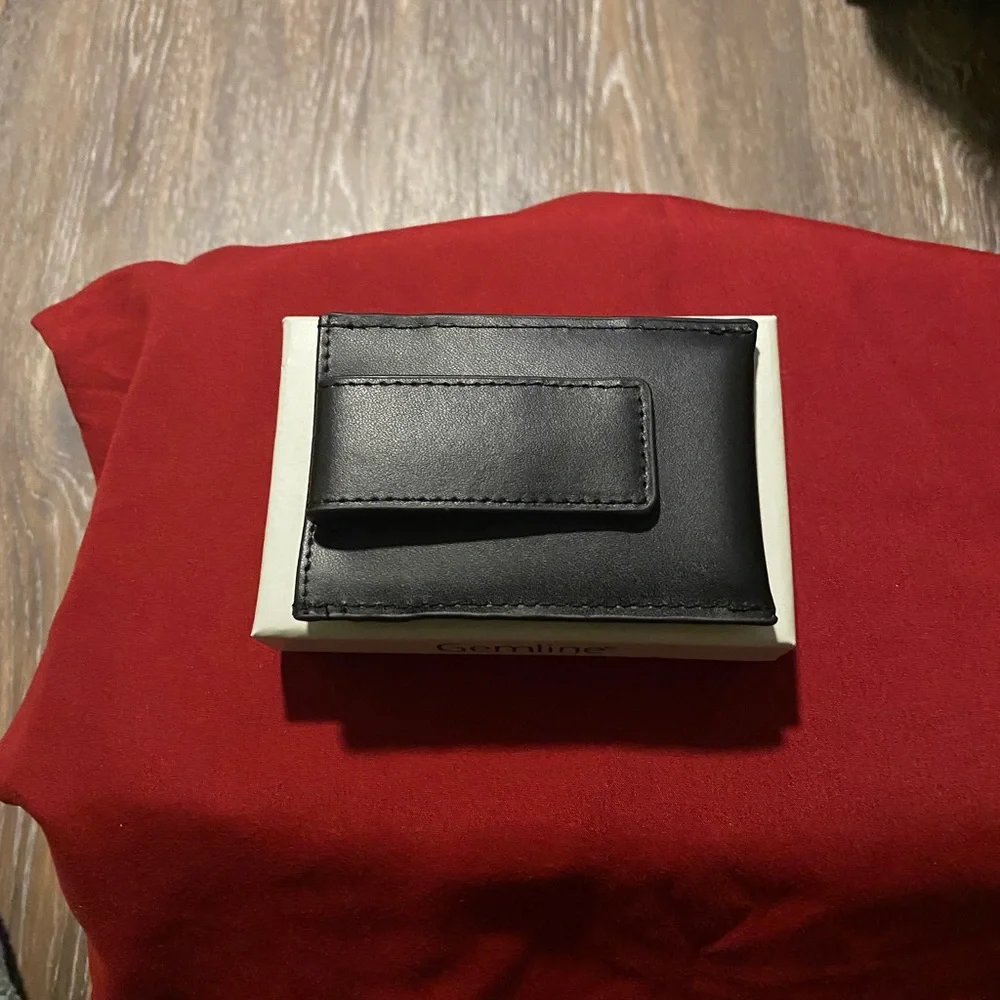Man’s black leather money clip & card holder.